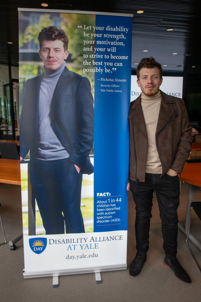  DAY Steering Committee member Nicholas Simons posing with his banner.